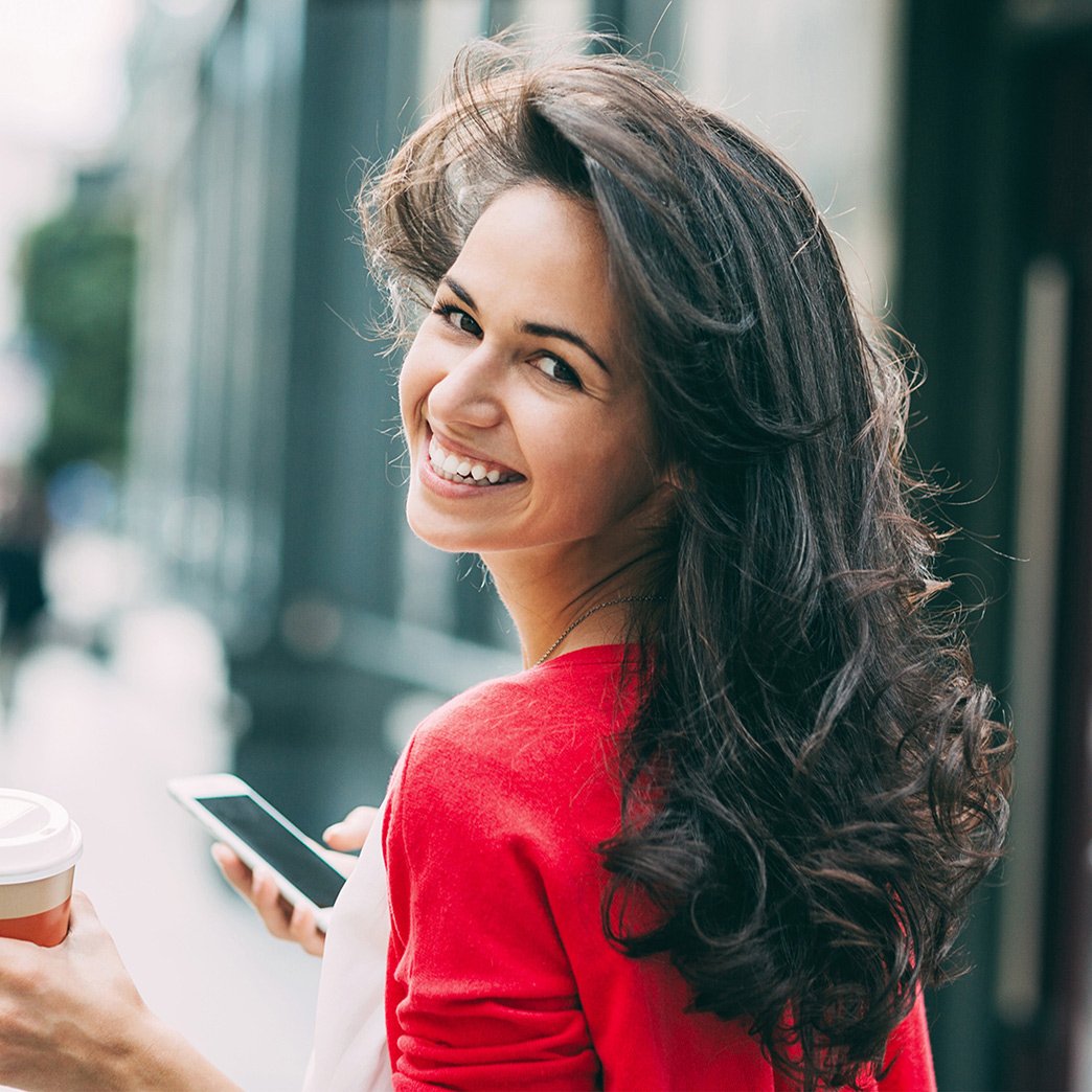 Woman with long hair looking back over her shoulder.